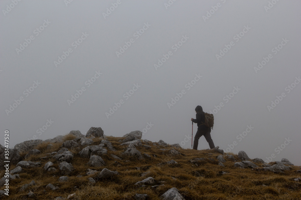 hikers in the mountains in the fog