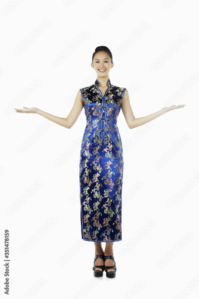 Woman in cheongsam smiling with arms outstretched Woman in cheongsam smiling with arms outstretched