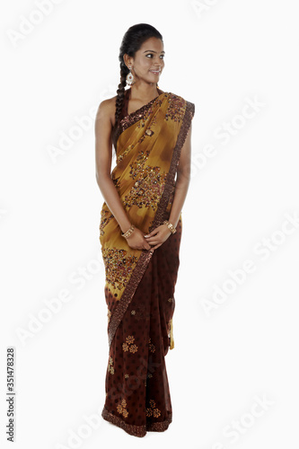 Woman in sari smiling and looking to the side