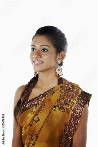 Woman in sari smiling and looking away