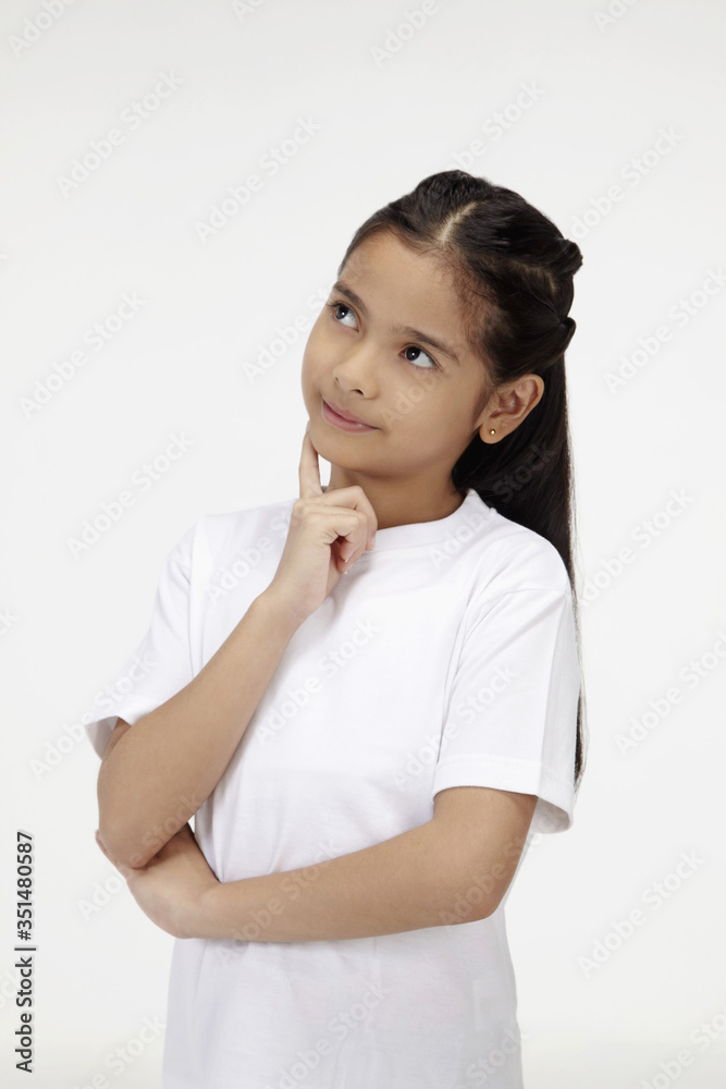 Girl with finger on cheek, contemplating