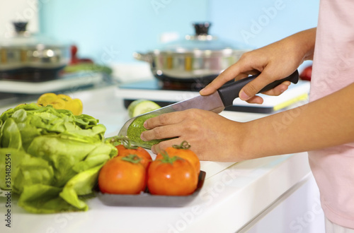 Woman cutting vegetables in the kitchen