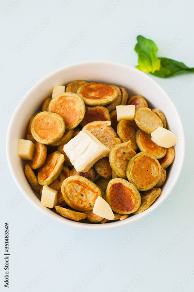 Spinach pancake cereals in a white bowl.