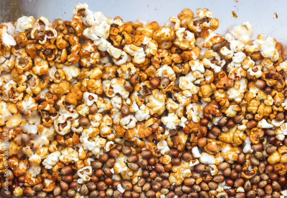 Sweet popcorn behind glass as an abstract background. Sweet popcorn behind glass as an abstract background.