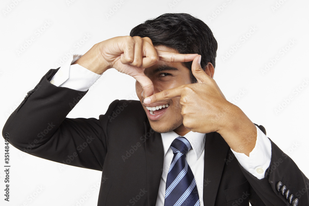 Young businessman making a frame with his fingers Young businessman making a frame with his fingers