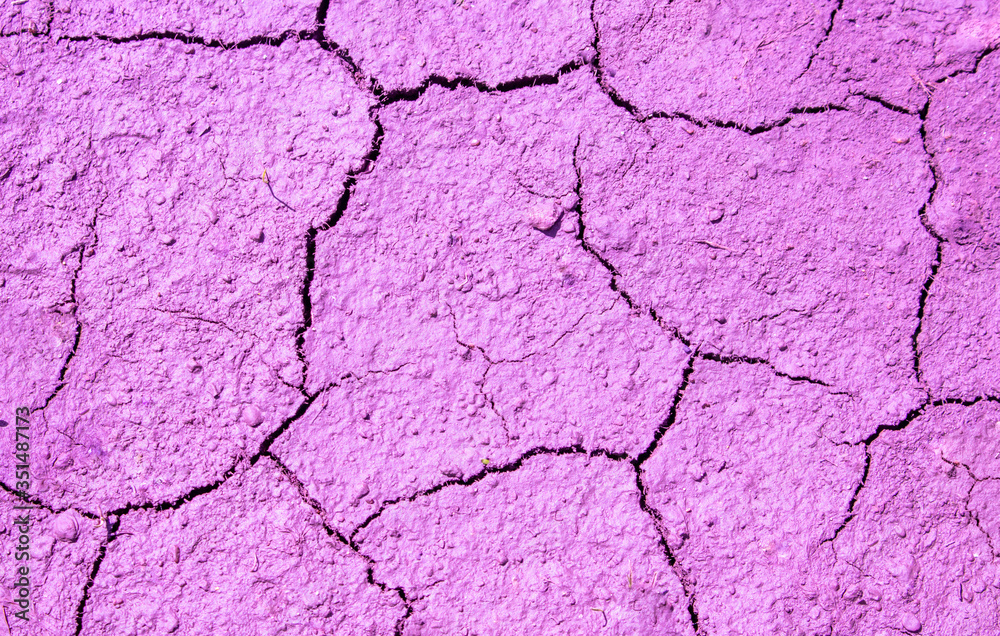 Pink cracked surface with a rough texture.Abstract background. Pink cracked surface with a rough texture.Abstract background.