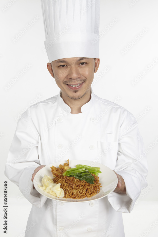 Asian chef with a plate of wonton noodles Asian chef with a plate of wonton noodles