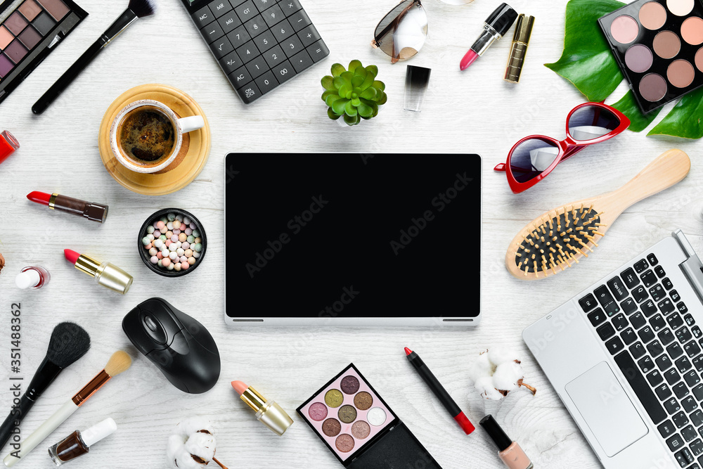 Female cosmetics on white office desk. Laptop, notepad, Lipstick, powder, comb, women's jewelry. Top view. Free space for your text. Flat lay. Female cosmetics on white office desk. Laptop, notepad, Lipstick, powder, comb, women's jewelry. Top view. Free space for your text. Flat lay.