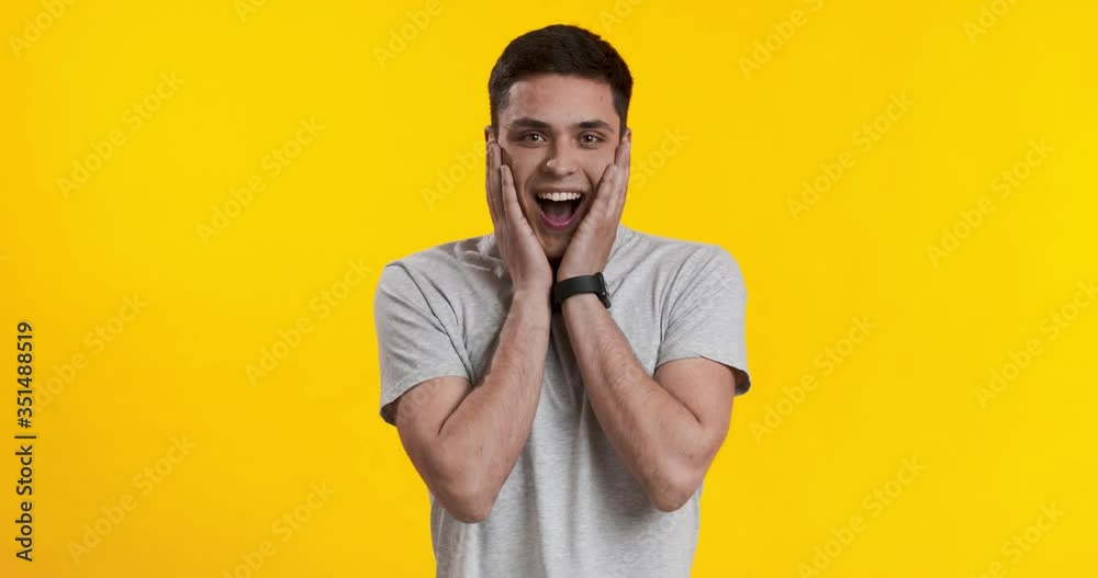 Shocked happy young guy looking at camera Shocked happy young guy looking at camera