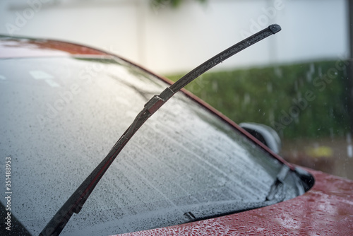 Cars parked in the rain in the rainy season and have a wiper system to clear the windshield from the windshield., Close-up car rain wipers, rainy weather and vehicles concept © เลิศลักษณ์ ทิพชัย