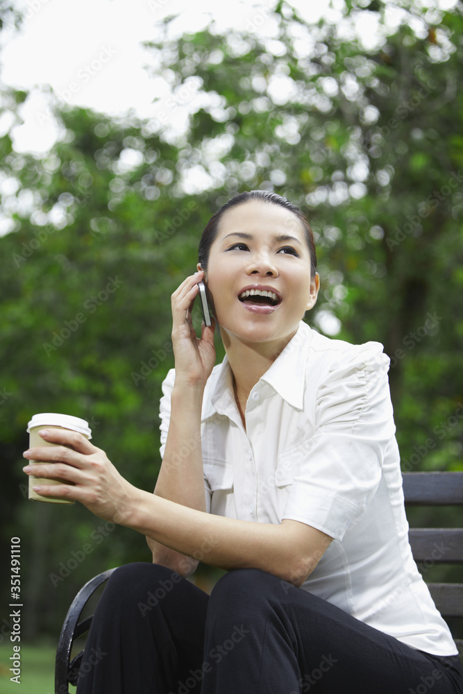 Mid adult businesswoman talking on smart phone Mid adult businesswoman talking on smart phone