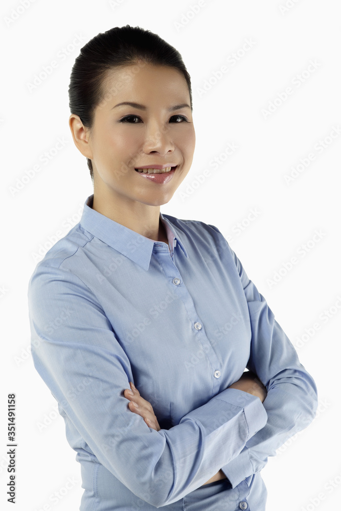 Mid adult businesswoman smiling with arms crossed Mid adult businesswoman smiling with arms crossed