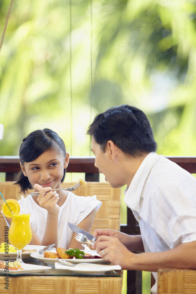 Girl feeding her father