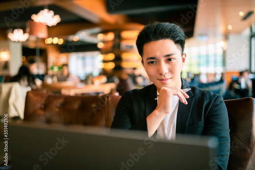 young Business man  Working On Laptop In Coffee Shop