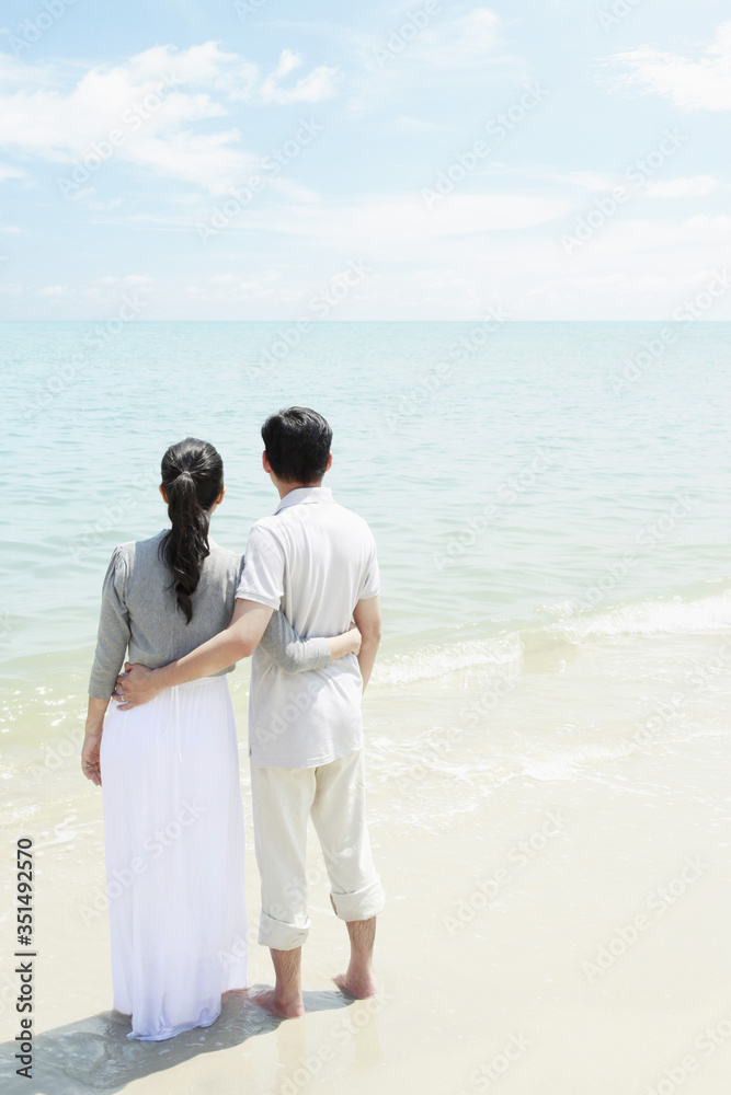 Man and woman enjoying the beautiful view on the beach Man and woman enjoying the beautiful view on the beach