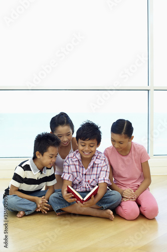 Group of children sharing a book