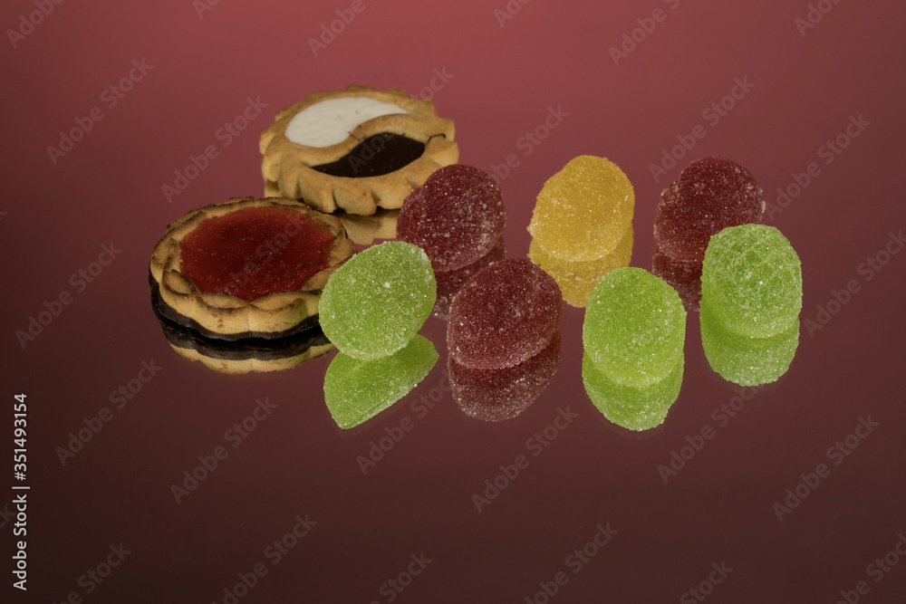 Several marmalade sweets isolated on a red background