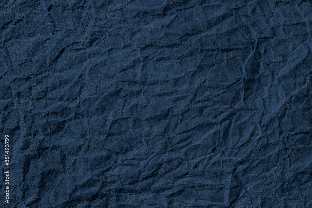 Fototapeta premium Crumpled dark blue paper textured background