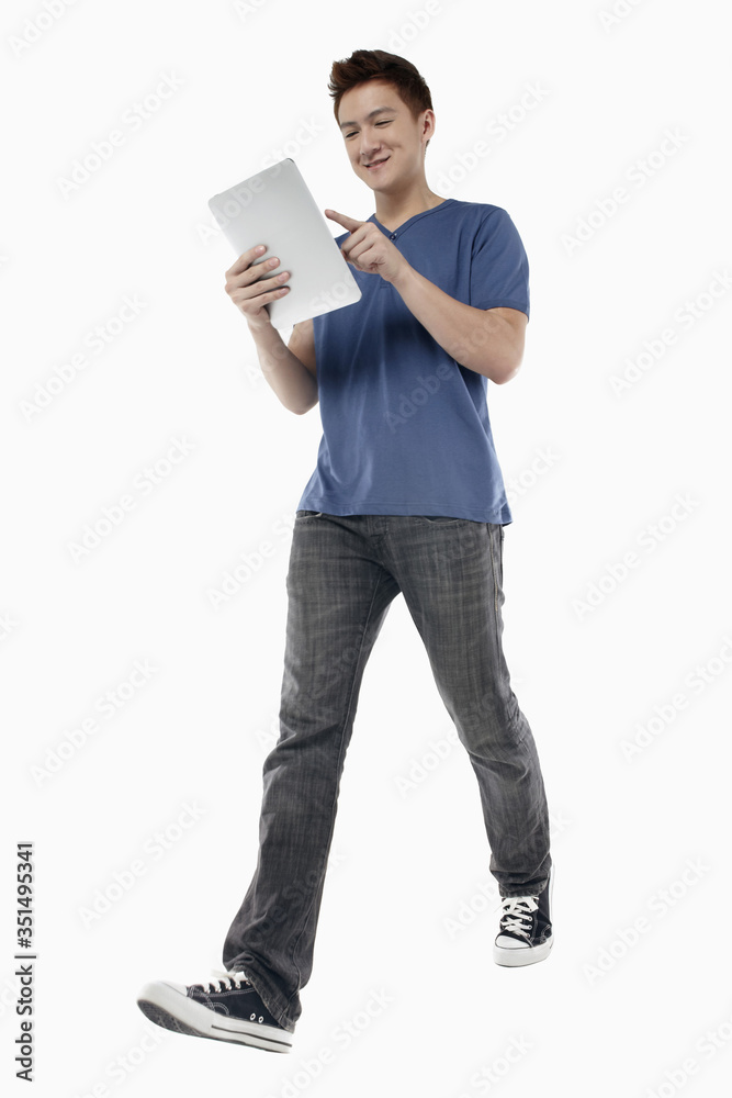 Man walking while using digital tablet Man walking while using digital tablet