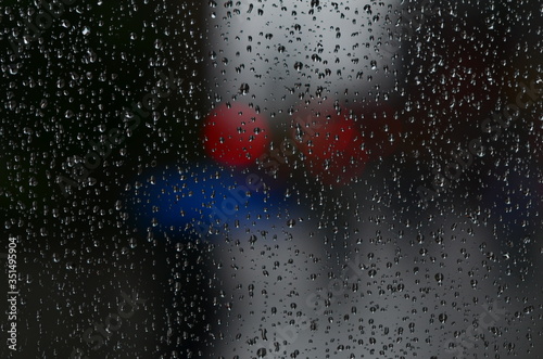 Window pane covered in raindrops photo