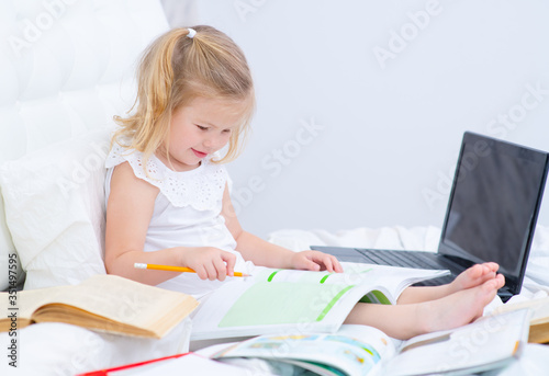 Girl doing homework remotely at home.