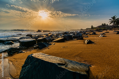 Beach with red sand and black rocks with a beautiful sundset in Congo Town, Monrovia, Liberia