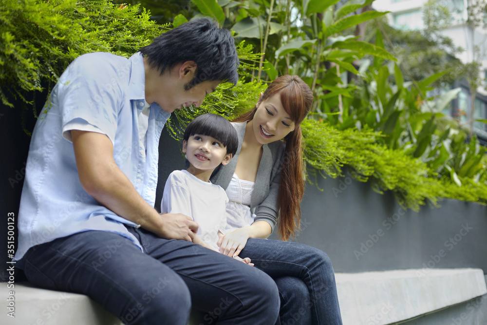 Fototapeta premium Family sitting together outdoors