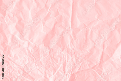 Crumpled salmon pink paper textured background