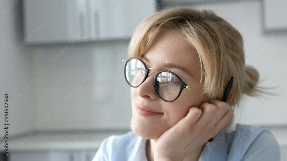Young lady in eyeglasses dreaming instead of work, creativity, close-up face Young lady in eyeglasses dreaming instead of work, creativity, close-up face