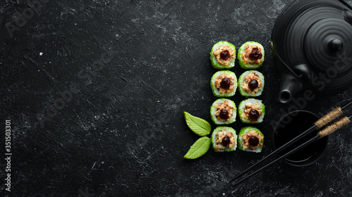 Green Sushi rolls - with eel fish and green Tobiko caviar. Pieces of delicious sushi. Top view.