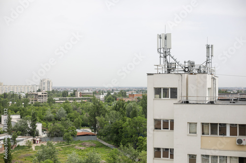 Communication antennas (4G and 5G) on top of a block of flats.