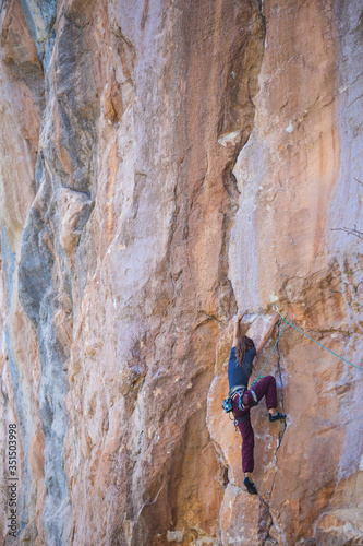 A strong girl climbs a rock, Rock climbing in Turkey.