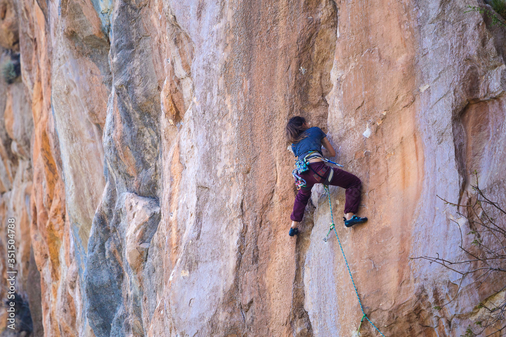 A strong girl climbs a rock, Rock climbing in Turkey. A strong girl climbs a rock, Rock climbing in Turkey.