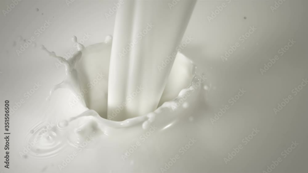 Close-up pouring milk in Slow Motion with crown splash. Shot with high speed camera. Close-up pouring milk in Slow Motion with crown splash. Shot with high speed camera.