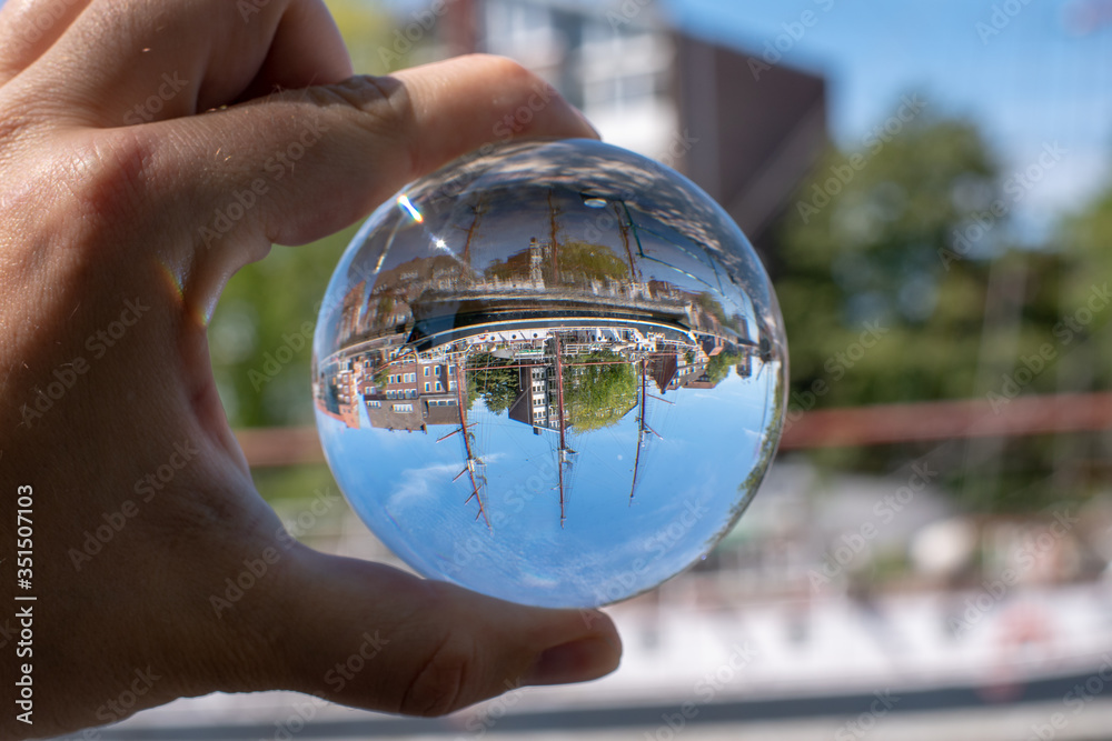 Emden harbor seen through a glass ball