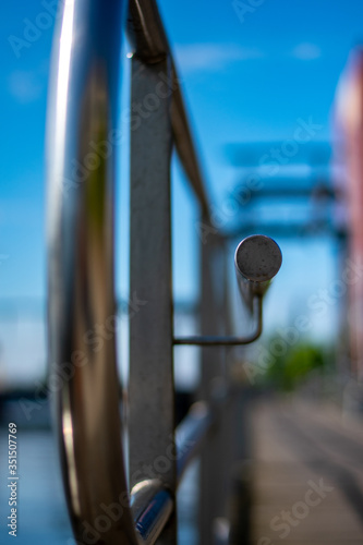 Railing in focus with Emder Harbor in the background