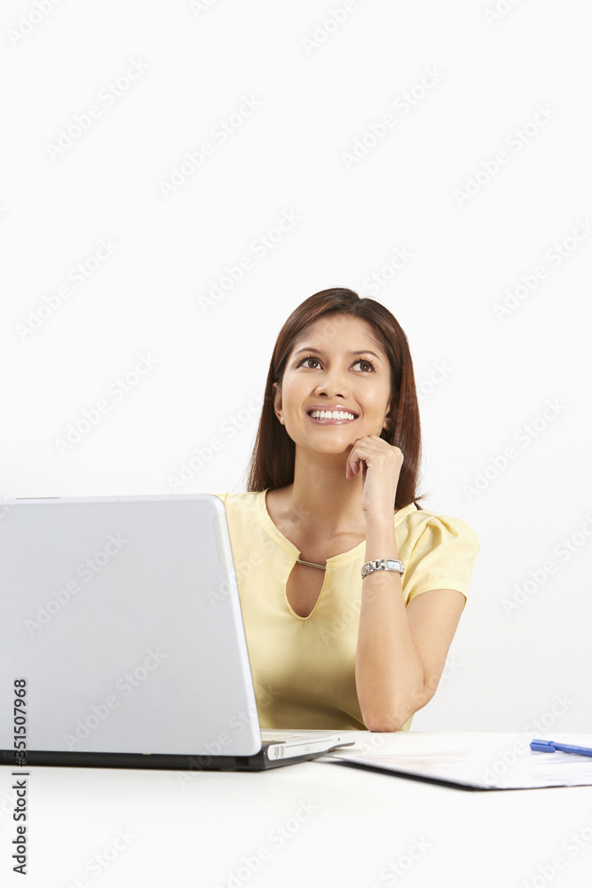 Businesswoman smiling while contemplating Businesswoman smiling while contemplating