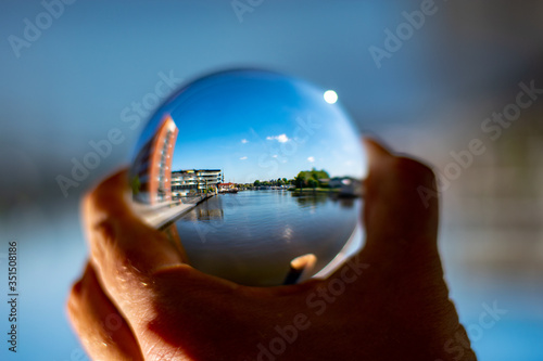 Emden harbor seen through a glass ball