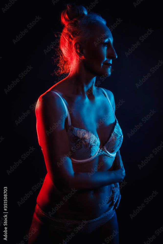 Portrait old woman in colorful bright lights .