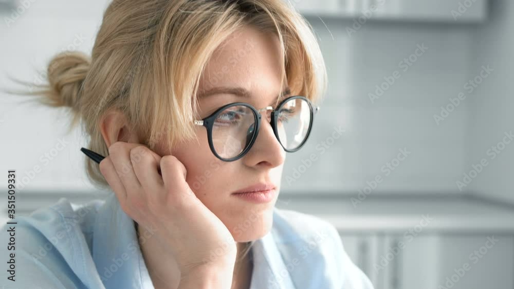 Bored lady trying to concentrate on work at home, closeup face of beautiful girl Bored lady trying to concentrate on work at home, closeup face of beautiful girl