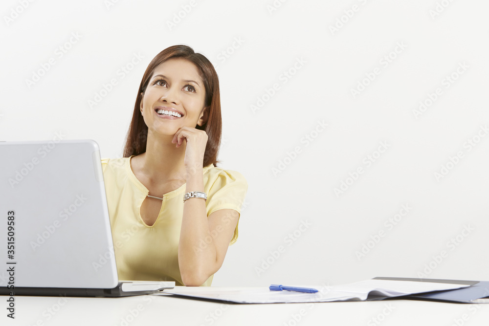 Businesswoman smiling while contemplating Businesswoman smiling while contemplating