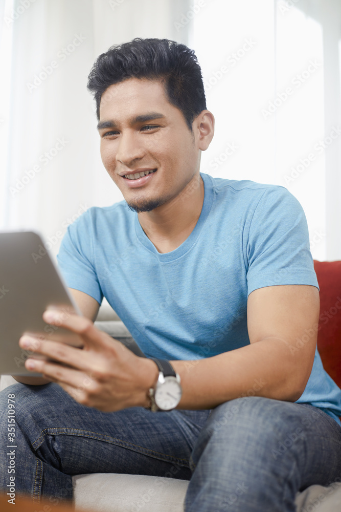 Man sitting and using digital tablet