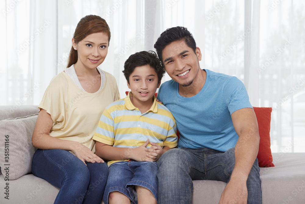 Family of three smiling at the camera Family of three smiling at the camera