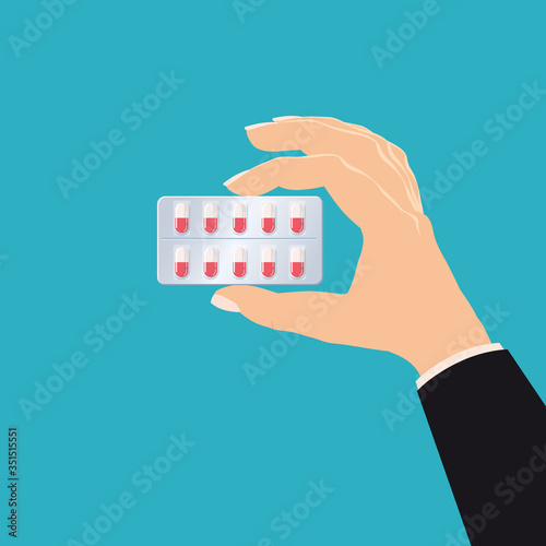 Hand holds medicine pharmacy blister red pills drug medicines