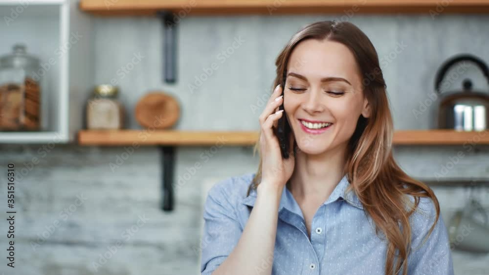 Close up face adorable blonde girl communicating on telephone at kitchen. Shot with RED camera in 4K Close up face adorable blonde girl communicating on telephone at kitchen. Shot with RED camera in 4K