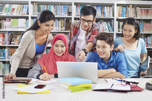 Students studying together in library