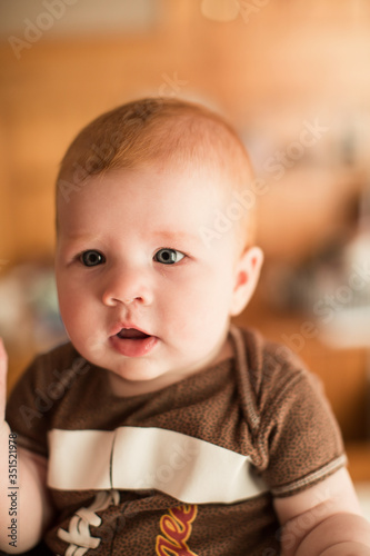 Cute seven month old baby girl sitting on the floor