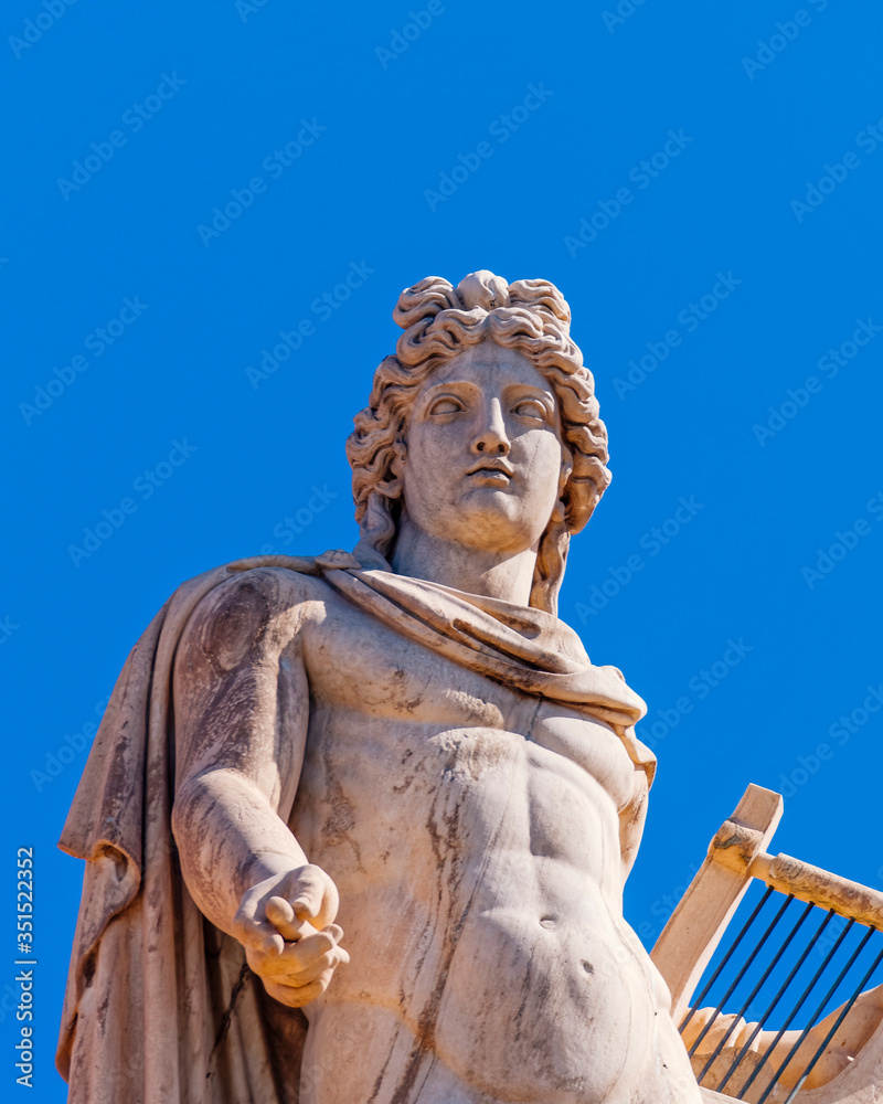 Athens Greece, Apollo ancient god of poetry and music marble statue on plain background