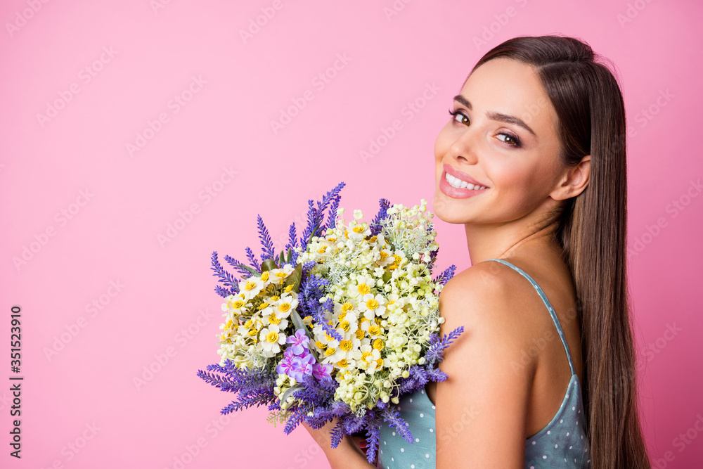Close-up profile side view portrait of her she nice-looking attractive lovely pretty winsome charming cute cheerful cheery girl holding in hands flowers isolated over pink pastel color background Close-up profile side view portrait of her she nice-looking attractive lovely pretty winsome charming cute cheerful cheery girl holding in hands flowers isolated over pink pastel color background