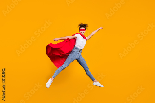Full length body size view of her she nice attractive lovely strong motivated fit slim cheerful cheery girl jumping wearing mantle isolated on bright vivid shine vibrant yellow color background © deagreez